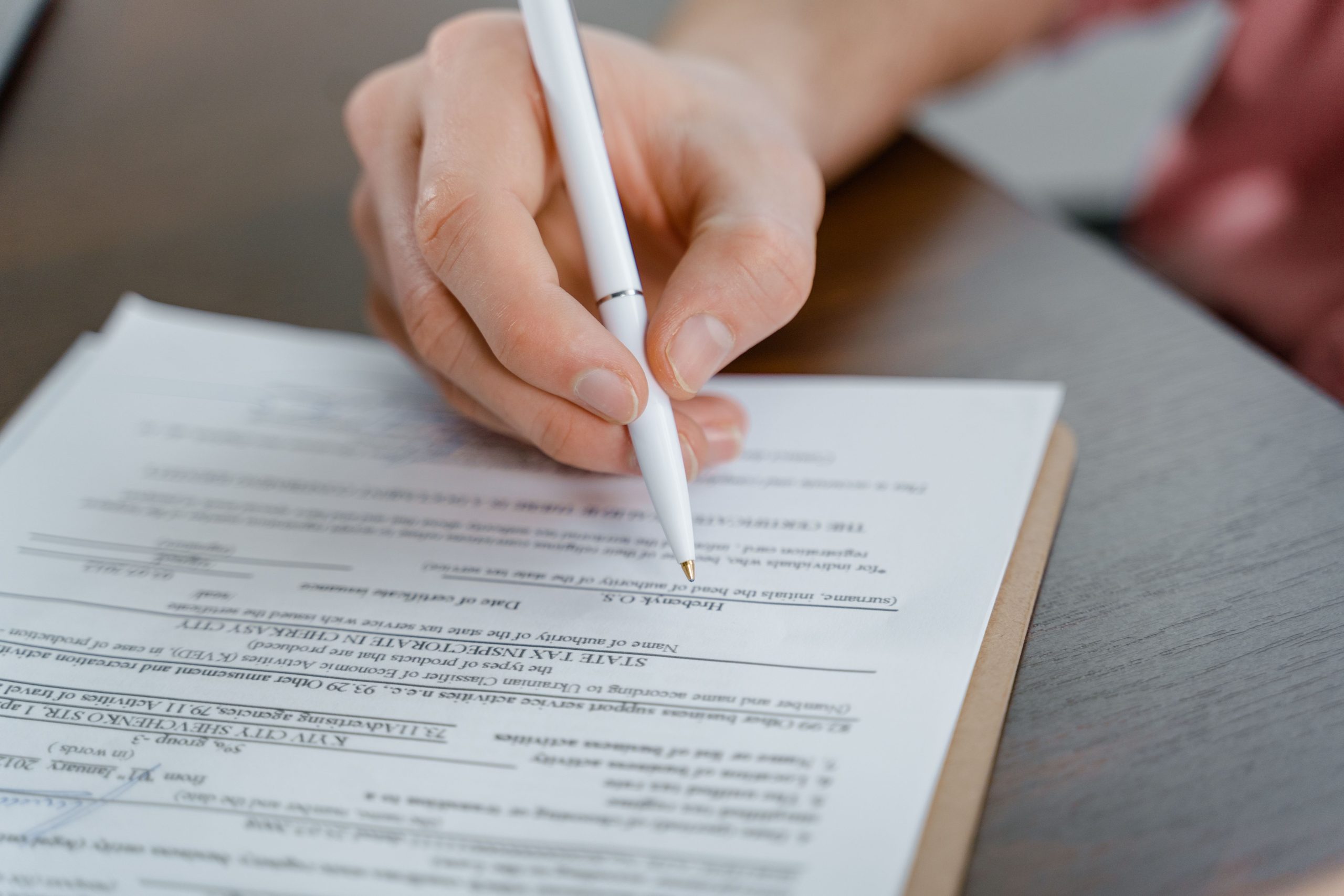 Main signant un document de commande avec stylo